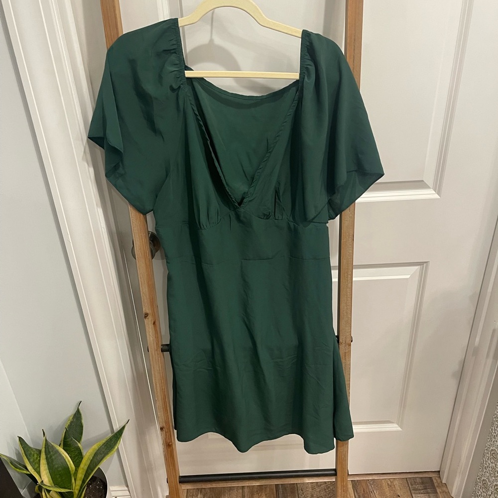 Green dress with flutter sleeve and plunging neckline